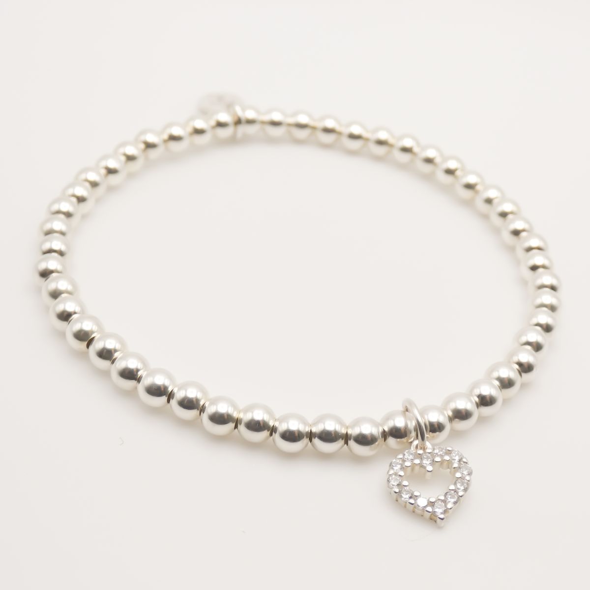 COACH Silvertone & Crystal Heart Charm Bangle Bracelet | The Pen Centre